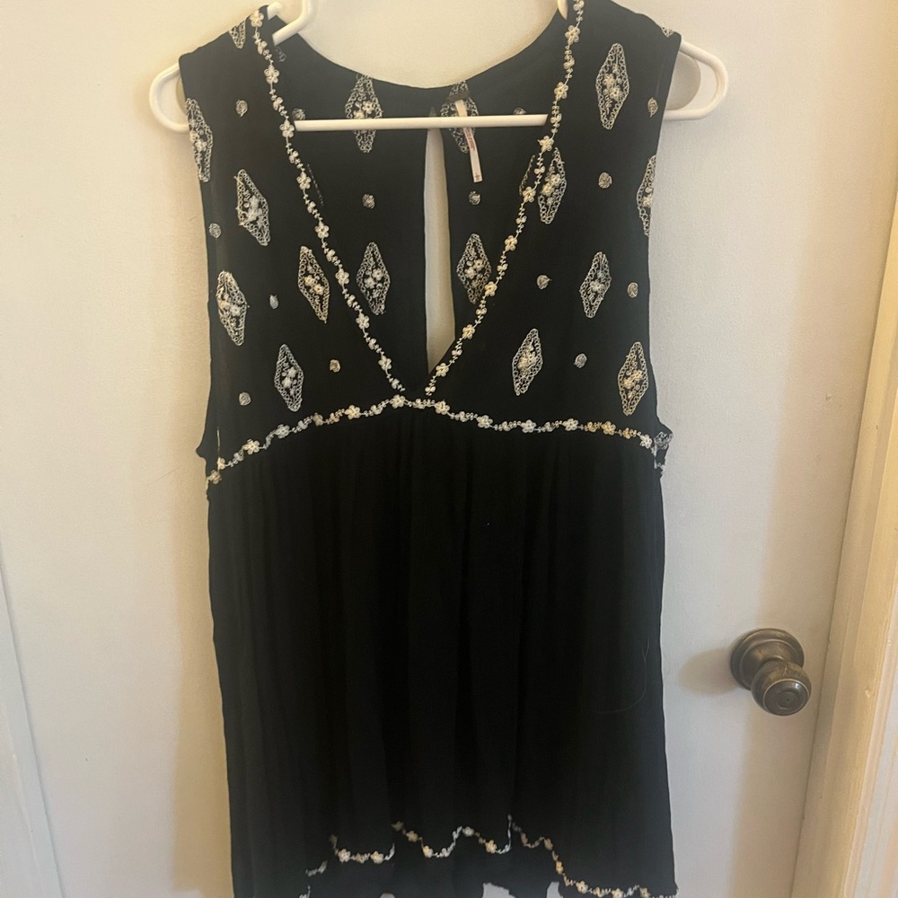 Black Sleeveless Top with White Embellishments